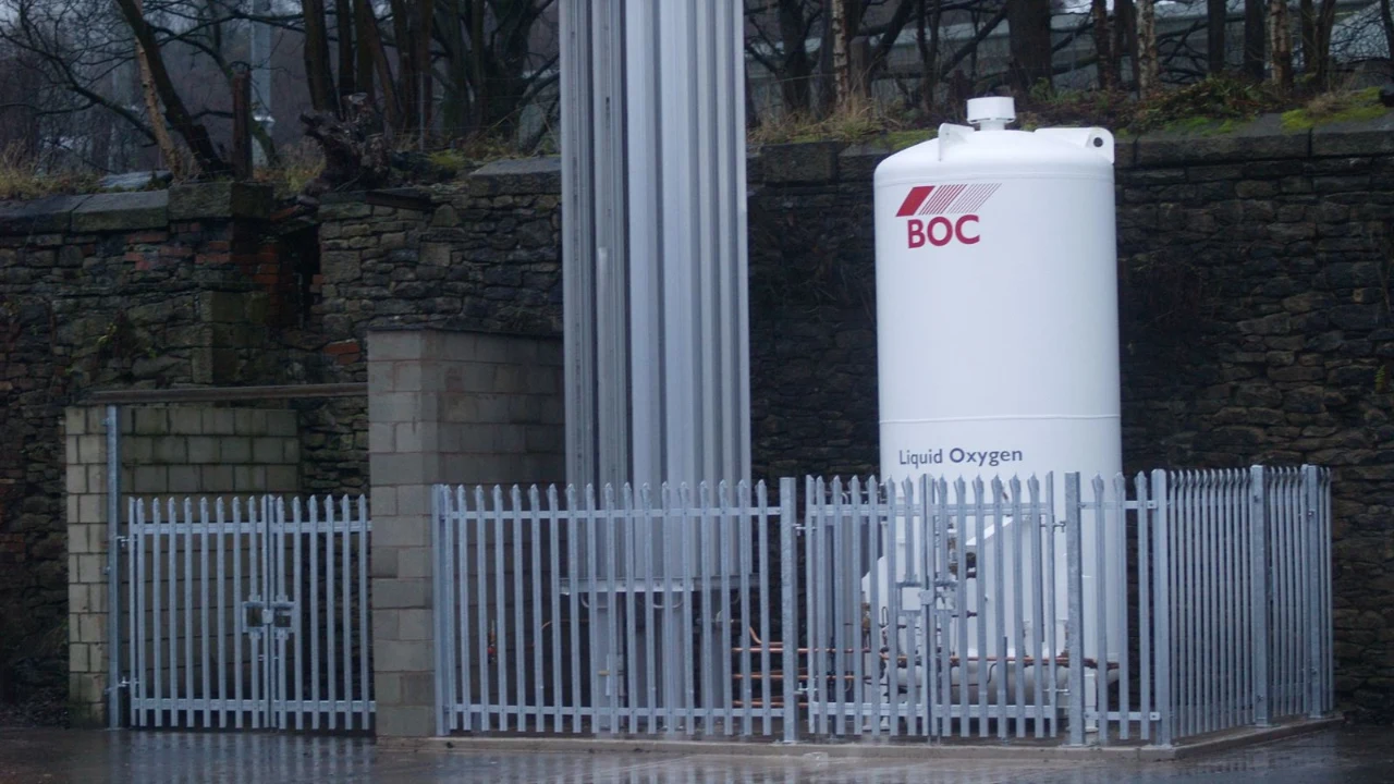 Galvanised palisade fencing securing an industrial gas storage compound